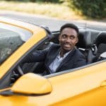 Menโs Health Screenings by Age: What to Know at 30, 40, 50+ A young man driving a sports car