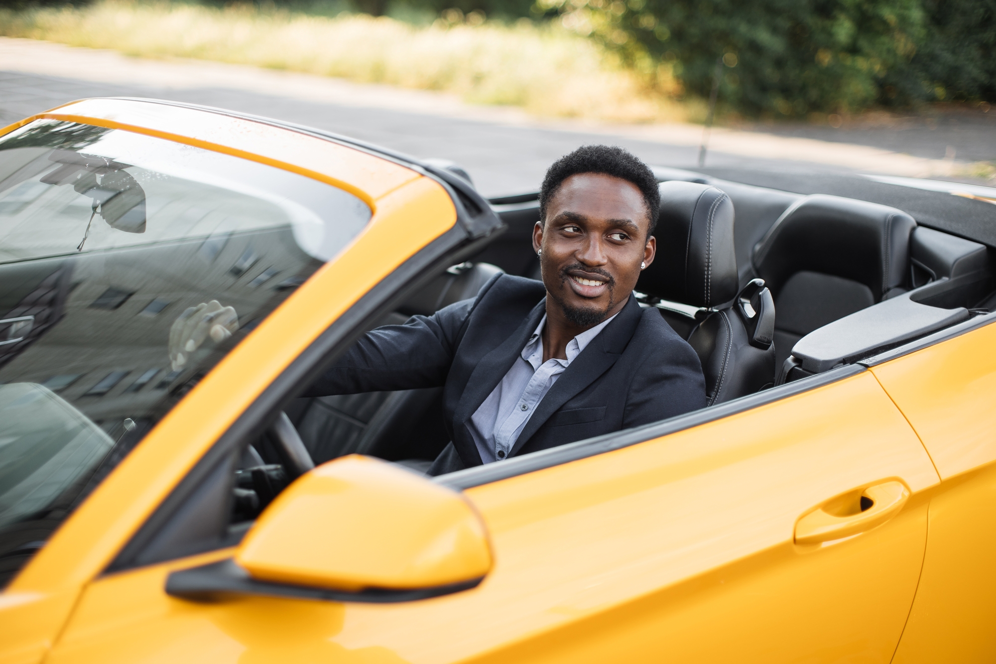 A young man driving a sports car